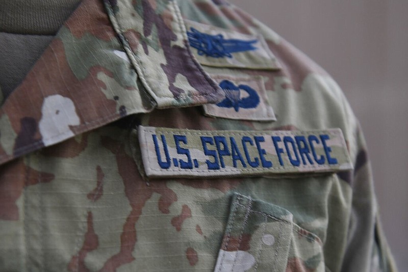 In this photo released by the U.S. Air Force, Capt. Ryan Vickers stands for a photo to display his new service tapes after taking his oath of office to transfer from the U.S. Air Force to the U.S. Space Force at Al-Udeid Air Base, Qatar, Tuesday, Sept. 1, 2020. Space Force, the first new U.S. military service since the creation of the Air Force in 1947, now has some 20 members stationed at Qatar's Al-Udeid Air Base in its first foreign deployment. (Staff Sgt. Kayla White/U.S. Air Force via AP)