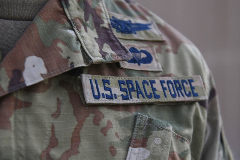 In this photo released by the U.S. Air Force, Capt. Ryan Vickers stands for a photo to display his new service tapes after taking his oath of office to transfer from the U.S. Air Force to the U.S. Space Force at Al-Udeid Air Base, Qatar, Tuesday, Sept. 1, 2020. Space Force, the first new U.S. military service since the creation of the Air Force in 1947, now has some 20 members stationed at Qatar's Al-Udeid Air Base in its first foreign deployment. (Staff Sgt. Kayla White/U.S. Air Force via AP) story.lead_photo.caption