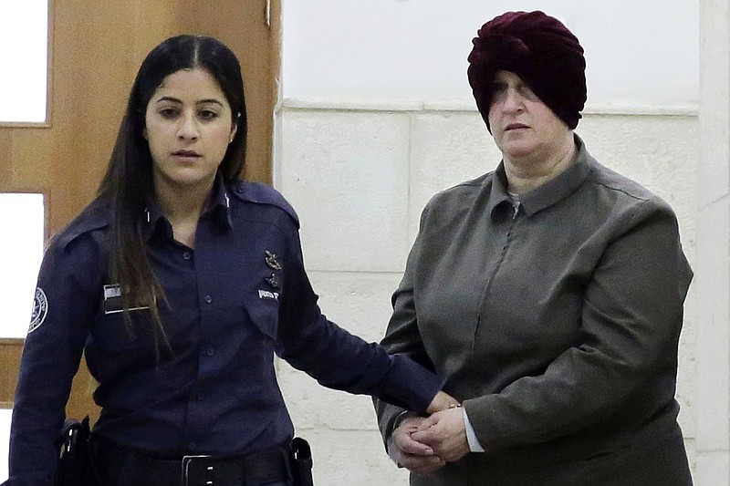 FILE - This Feb. 27, 2018, file photo, Australian Malka Leifer, right, is brought to a courtroom in Jerusalem. An Israeli court on Monday, Sert. 21, 2020 approved the extradition of the former teacher wanted in Australia on charges of child sex abuse, paving the way for her to stand trial after a six-year legal battle. (AP Photo/Mahmoud Illean, File)