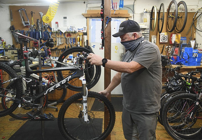 Bruce Hubbard of Parkside Cycle, 719 Whittington Ave., gives a tour of his bike shop on Tuesday. - Photo by Grace Brown of The Sentinel-Record