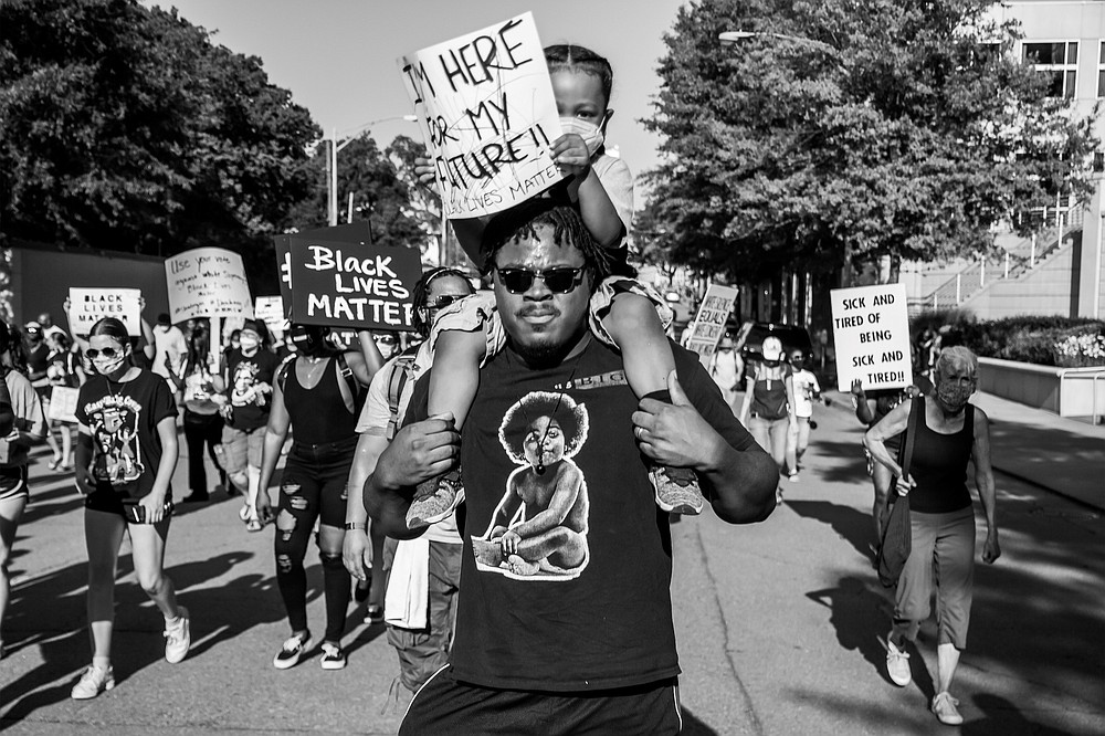 "Untitled (Man with child)," 2020, digital print by Ebony Blevins, is part of the "Let Us March On" exhibition at Hendrix College in Conway.
(Special to the Democrat-Gazette)