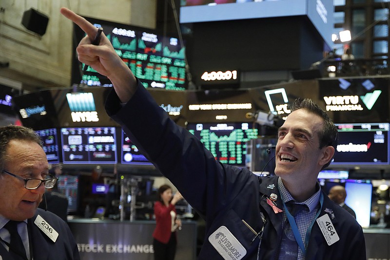 FILE - In this March 10, 2020, file photo, traders Steven Kaplan, left, and Gregory Rowe react at the closing on the floor of the New York Stock Exchange. Wall Street is opening slightly higher, Tuesday, Sept. 22, 2020, as markets recover from steep losses Monday. (AP Photo/Richard Drew, File)