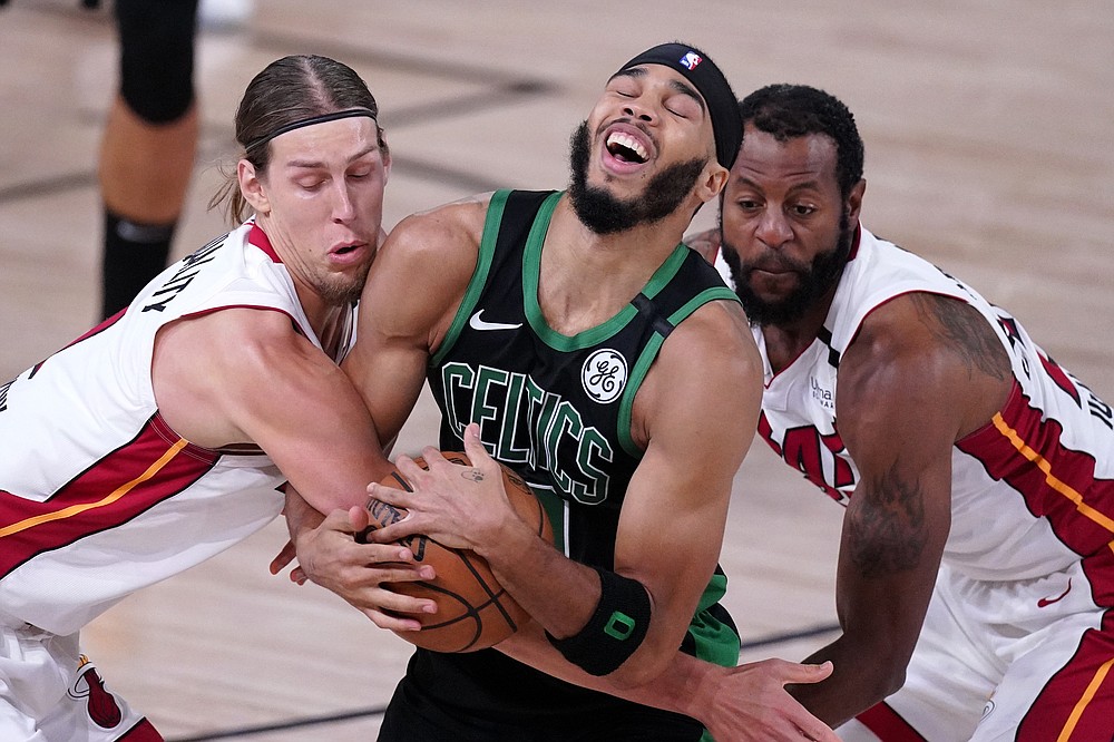 Miami Heat forward Duncan Robinson (55) goes after a loose ball against  Boston Celtics guard Jaylen Brown (7) during the second quarter of game  seven of the Eastern Conference Finals for the