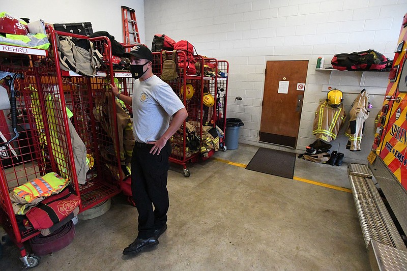 Springdale fire Capt. James Kehrli stands Tuesday near the firefighters equipment storage area that is in the same bay as the trucks at Station No. 4. The Fire Department hopes to soon renovate the station. Go to nwaonline.com/200922Daily/ and nwadg.com/photos for a photo gallery. (NWA Democrat-Gazette/J.T. Wampler)
