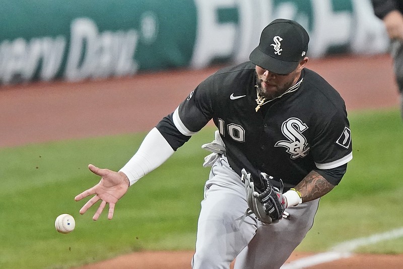 Chicago White Sox's Yoan Moncada can't hang onto a ball hit by Cleveland Indians' Franmil Reyes in the sixth inning of a baseball game, Tuesday, Sept. 22, 2020, in Cleveland. Reyes was safe at first base. (AP Photo/Tony Dejak)