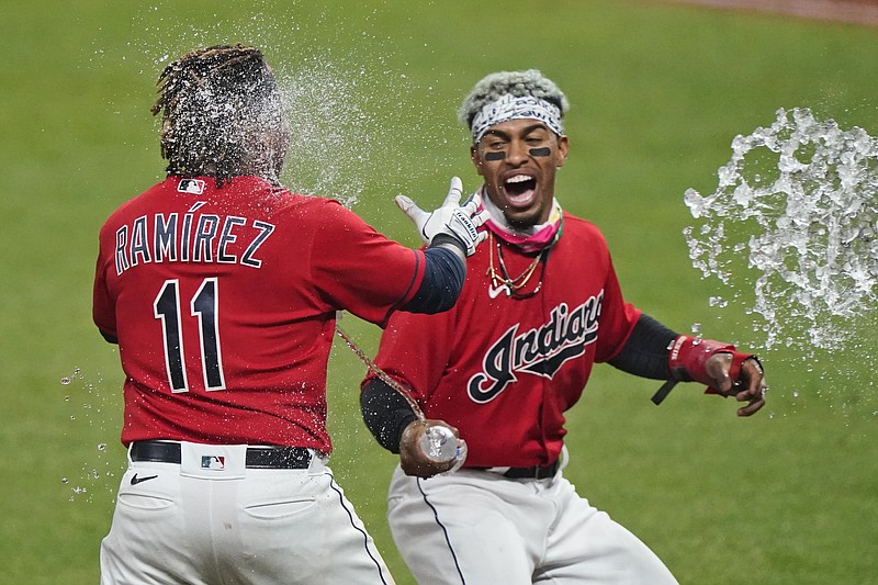 Cleveland Indians' Francisco Lindor, right, tosses water on Jose Ramirez after Ramirez hit a three-run home run in the 10th inning of Tuesday's game against the Chicago White Sox in Cleveland. The Indians won in ten innings. - Photo by Tony Dejak of The Associated Press