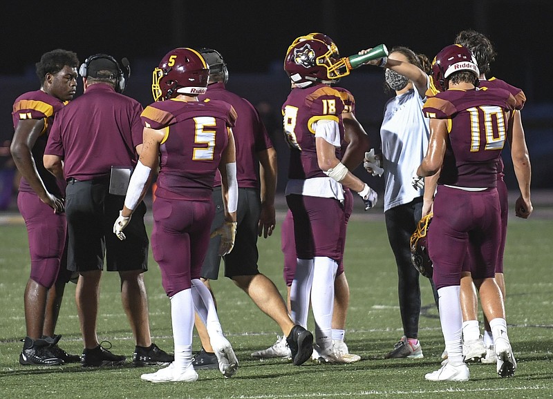 Lake Hamilton players huddle and refresh during a Sept. 11 game against Malvern at Wolf Stadium. The Wolves host Mountain Home on Friday to open their 6A-West conference season. - Photo by Grace Brown of The Sentinel-Record