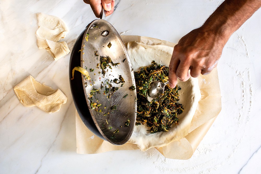 Sauteed spinach and onion flavored with chermoula fill this savory pie. (The New York Times/Andrew Scrivani)