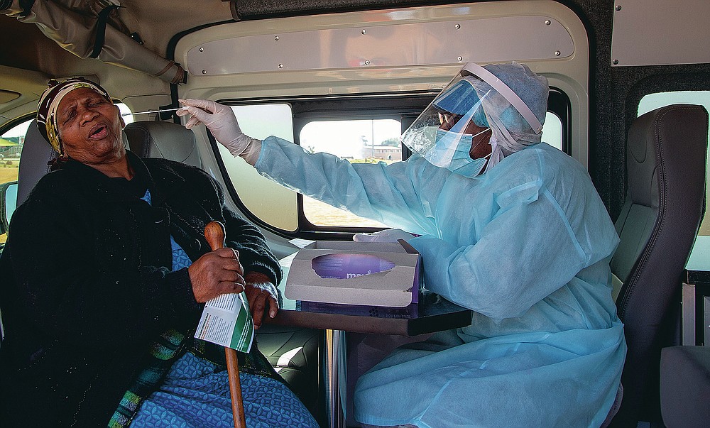 FILE - In this May 22, 2020, file photo, an elderly woman reacts as a heath worker collects a sample during the screening and testing campaign aimed to combat the spread of COVID-19 at Sphamandla, an informal settlement in Katlehong, south of Johannesburg, South Africa. The coronavirus pandemic has fractured global relationships, but John Nkengasong, Africa's top public health official, has helped to steer the continent's 54 countries into an alliance praised as responding better than some richer nations. (AP Photo/Themba Hadebe, File)