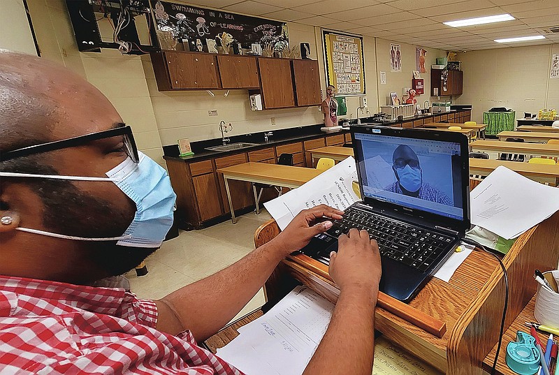 By Eplunus Colvin 
Watson Chapel High School Teacher Cameran Faucette, who taught Chromebook Boot Camp to parents, prepares to teach his third-period Biology virtual students.