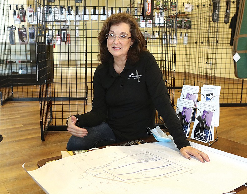 Mountain Valley Armory co-owner Tayna Spavins discusses the new Machine Gun Grotto firing range going in MVA’s basement on Friday. - Photo by Richard Rasmussen of The Sentinel-Record