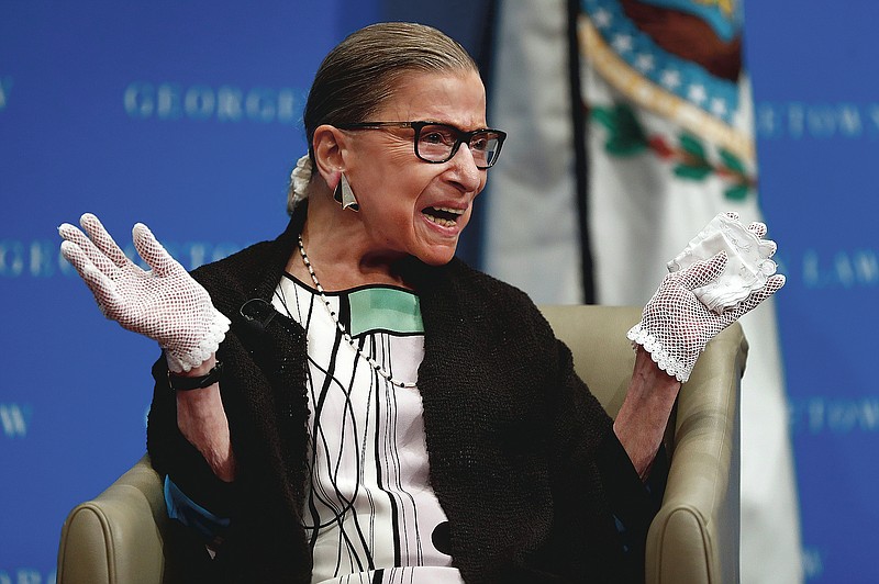 FILE - In this Sept. 20, 2017 file photo, U.S. Supreme Court Justice Ruth Bader Ginsburg reacts to applause as she is introduced by William Treanor, Dean and Executive Vice President of Georgetown University Law Center, at the Georgetown University Law Center campus in Washington. On Friday, Sept. 24, 2020, The Associated Press reported on stories circulating online incorrectly claiming Ginsburg wanted to lower the age of consent for sex to 12 years old. This bogus claim first emerged during Ginsburg’s 1993 confirmation hearings when official testimony misinterpreted a recommendation by Ginsburg in a 1977 report published by the United States Commission on Civil Rights. (AP Photo/Carolyn Kaster, File)