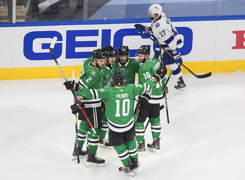 Dallas Stars defenseman John Klingberg (3) celebrates his goal with teammates as Tampa Bay Lightning center Alex Killorn (17) skates past Friday during the first period of Game 4 of the NHL hockey Stanley Cup Final in Edmonton, Alberta. - Photo by Jason Franson/The Canadian Press via The Associated Press