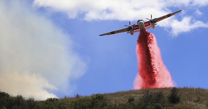 Cal Fire air tankers help stop the spread of a brush fire in Larkfield Calif, Thursday. - Kent Porter/The Press Democrat via AP