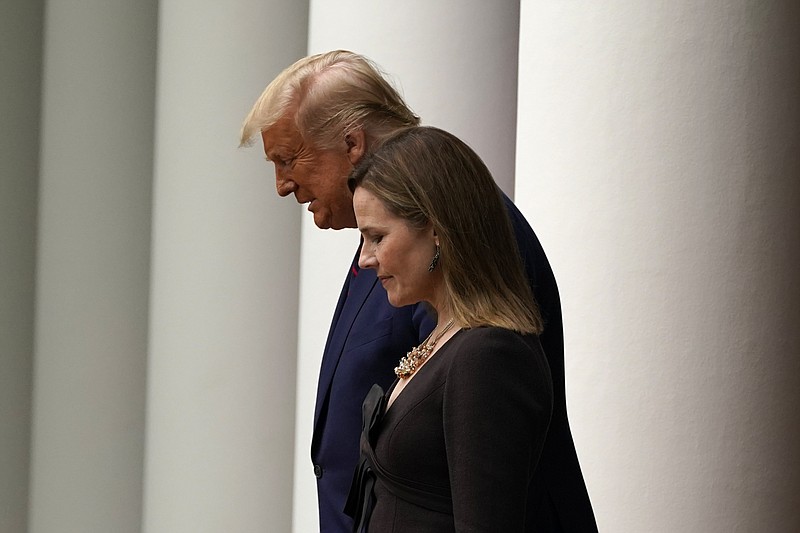 President Donald Trump walks with Judge Amy Coney Barrett to a news conference to announce Barrett as his nominee to the Supreme Court, in the Rose Garden at the White House, Saturday, in Washington. - AP Photo/Alex Brandon