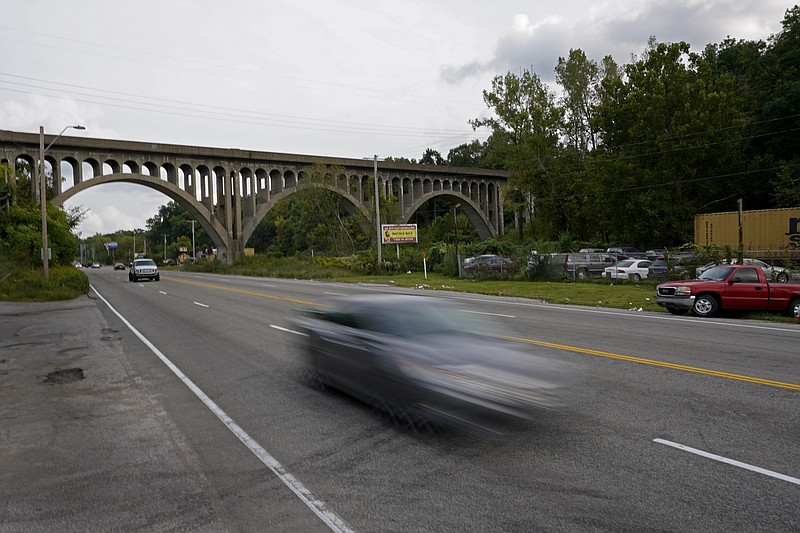 Cars travel under a landmark railroad viaduct on a stretch of Blue Parkway Tuesday, Sept. 22, 2020, in Kansas City, Mo. The stretch of road, along with parts of two other streets, would be renamed to honor Rev. Martin Luther King Jr. under a city proposal coming in the wake of failed effort to honor King last year. (AP Photo/Charlie Riedel)