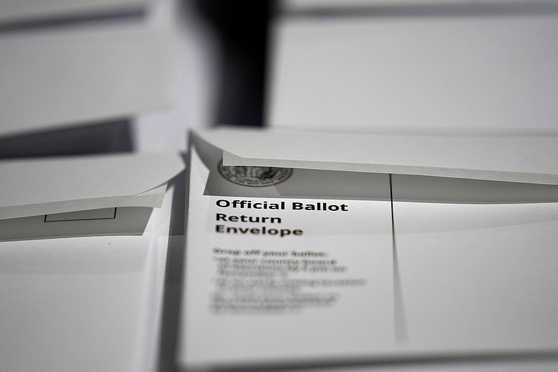 FILE - In this Sept. 3, 2020, file photo, stacks of ballot envelopes waiting to be mailed are seen at the Wake County Board of Elections in Raleigh, N.C. Black voters are among the least likely to vote by mail nationally, but there are early signs they are changing their behavior as the shadow of the coronavirus hangs over the presidential race. The evidence is clearest in North Carolina, the first state in the nation to send out mail ballots and where voting has been underway for almost three weeks. (AP Photo/Gerry Broome, File)