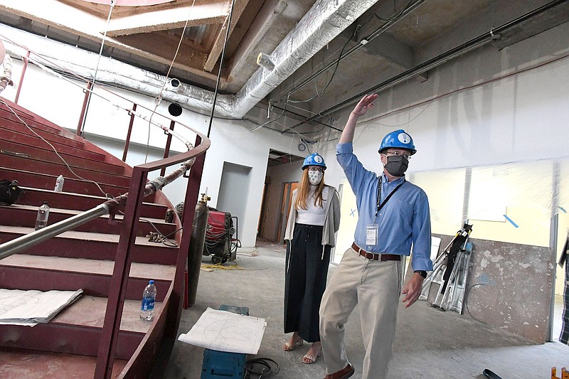 Library director David Johnson (right) and development manager Roxi Hazelwood stand near the grand staircase in the expansion of the Fayetteville Public Library under construction Thursday Sept. 24, 2020. Administrators hope to open the newly expanded library by mid- to late November or early December. The library will nearly double in size, with an expanded youth services area, more collaboration spaces, a 700-seat multipurpose room and a dedicated genealogy research section. Visit nwaonline.com/200924Daily/ and nwadg.com/photos for more photos. (NWA Democrat-Gazette/J.T.WAMPLER)