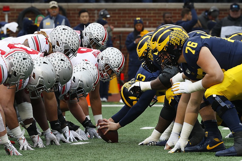 FILE- In this Nov. 30, 2019, file photo, Ohio State, left, and Michigan players line up at the line of scrimmage in the first half of an NCAA college football game in Ann Arbor, Mich. The Big Ten's third football schedule of the 2020 season is highlighted by Michigan-Ohio State on Dec. 12, the final day of the conference's regular-season and the latest date the rivals have ever played.(AP Photo/Paul Sancya, File)