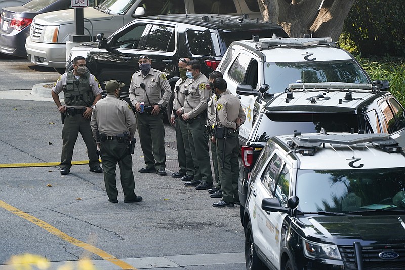 FILE - Police officers stand outside St. Francis Medical Center on Sept. 14 in Lynwood, Calif. after two Los Angeles County Sheriff's deputies were shot in an apparent ambush.  Recent shootings of police officers and protests that have left scores of officers injured are stark reminders of the dangers facing law enforcement around a country grappling with police killings of African Americans. - AP Photo/Ashley Landis