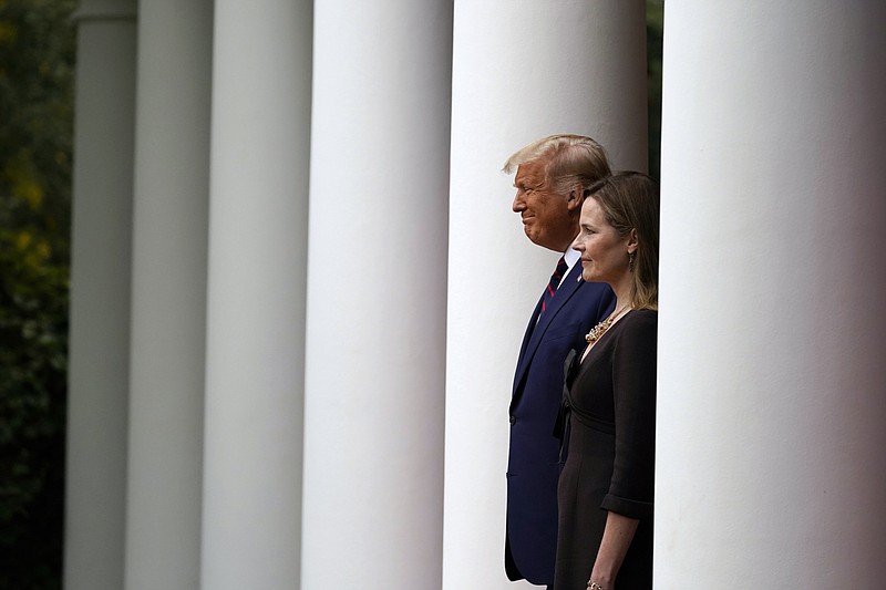 President Donald Trump walks with Judge Amy Coney Barrett to a news conference to announce Barrett as his nominee to the Supreme Court, in the Rose Garden at the White House Saturday in Washington. - AP Photo/Alex Brandon