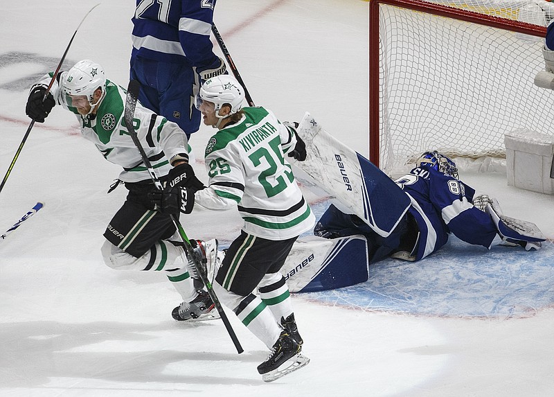 Dallas Stars right wing Corey Perry (10) celebrates his goal against Tampa Bay Lightning goaltender Andrei Vasilevskiy (88) with Joel Kiviranta (25) during the second overtime in Game 5 of the NHL hockey Stanley Cup Final, Saturday, Sept. 26, 2020, in Edmonton, Alberta. (Jason Franson/The Canadian Press via AP)