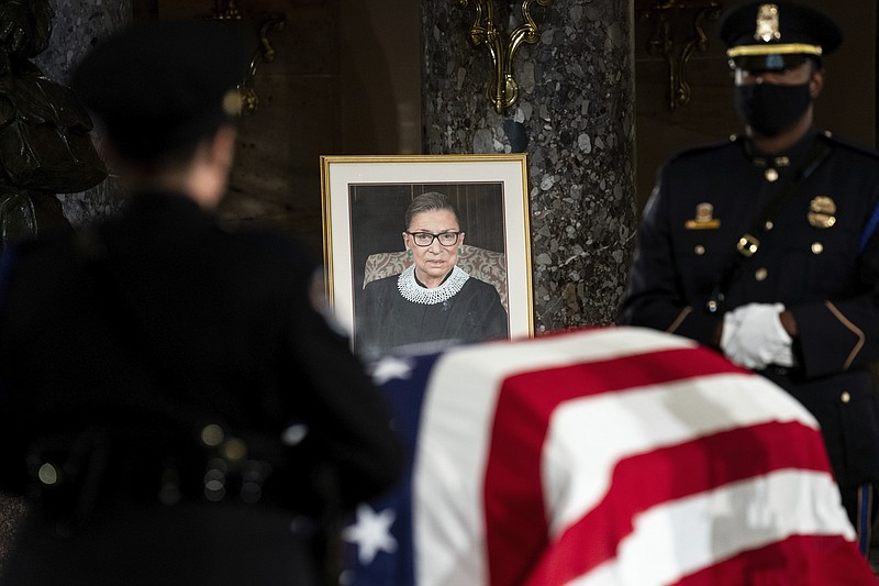 The flag-draped casket of Justice Ruth Bader Ginsburg lies in state in the U.S. Capitol on Friday. Ginsburg died at the age of 87 on Sept. 18 and is the first women to lie in state at the Capitol. - Erin Schaff/The New York Times via AP