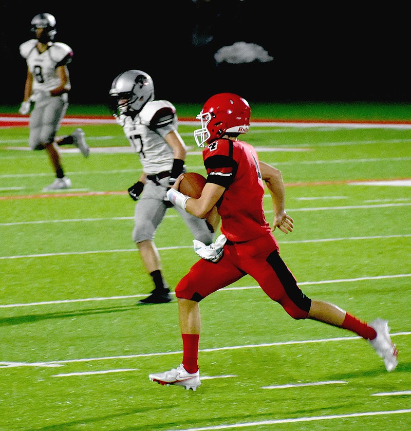 MARK HUMPHREY  ENTERPRISE-LEADER/Farmington quarterback Cameron Vanzant tries to run out-of-bounds on the last play of the junior Cardinals' 17-14 loss to Siloam Springs in a junior high game Thursday at Cardinal Stadium.