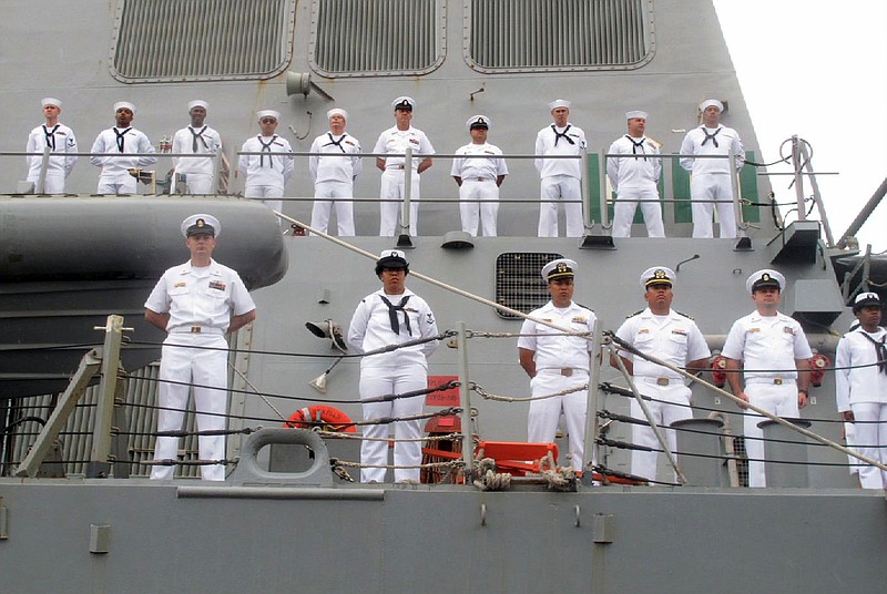 FILE - In this Aug. 8, 2016, file photo, U.S. Navy sailors stand on deck of the guided missile destroyer USS Benfold as it arrives in port in Qingdao in eastern China's Shandong Province,  U.S.-China friction has flared again, with Beijing firing back at accusations by Washington that it is a leading cause of global environmental damage and has reneged on its promise not to militarize the South China Sea. (AP Photo/Borg Wong, File)