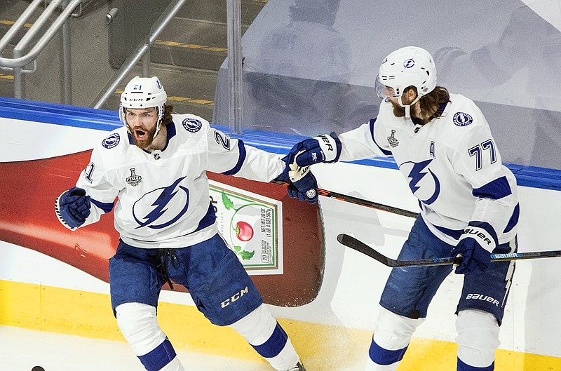 Tampa Bay Lightning's Brayden Point (21) celebrates his goal against the Dallas Stars with Victor Hedman (77) during first-period NHL Stanley Cup finals hockey game action in Edmonton, Alberta, Monday, Sept. 28, 2020. (Jason Franson/The Canadian Press via AP)