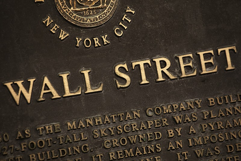 FILE - In this May 26, 2020 file photo, a historic marker for Wall Street is shown in New York's financial district. Stocks are off to a mixed start on Wall Street Tuesday, Sept. 29 as the market cooled off following a rally the day before and as investors waited for the presidential debate between former Vice President Joe Biden and President Donald Trump. Banks and industrial companies had some of the biggest losses shortly after the opening bell Tuesday, while several big technology and communications companies were higher. (AP Photo/Mark Lennihan, File)