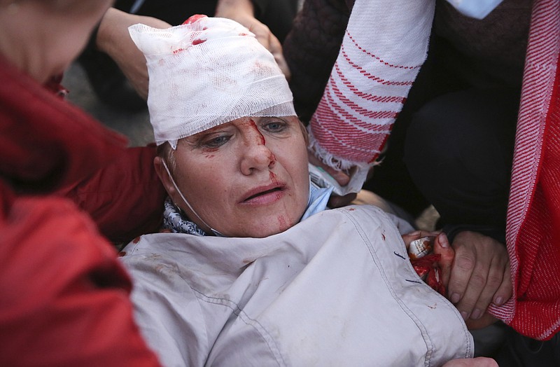 Two women provide a health care to a wounded protester during an opposition rally to protest the presidential inauguration in Minsk, Belarus, Wednesday, Sept. 23, 2020. Belarus President Alexander Lukashenko has been sworn in to his sixth term in office at an inaugural ceremony that was not announced in advance amid weeks of huge protests saying the authoritarian leader's reelection was rigged. Hundreds took to the streets in several cities in the evening to protest the inauguration. (AP Photo/TUT.by)