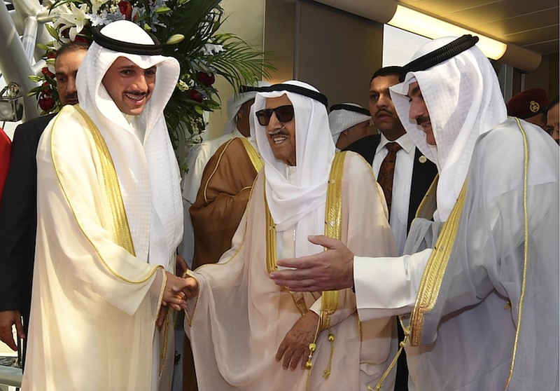 FILE - In this Wednesday, Oct. 16, 2019 file photo released by Kuwait News Agency, KUNA, Emir of Kuwait Sheikh Sabah al-Ahmad al-Sabah, middle, receives by Kuwaiti officials after his arrival from the U.S. in Kuwait. Kuwait state television said Tuesday, Sept. 29, 2020, the country's 91-year-old ruler, Sheikh Sabah Al Ahmad Al Sabah, had died. ( KUNA via AP, File)