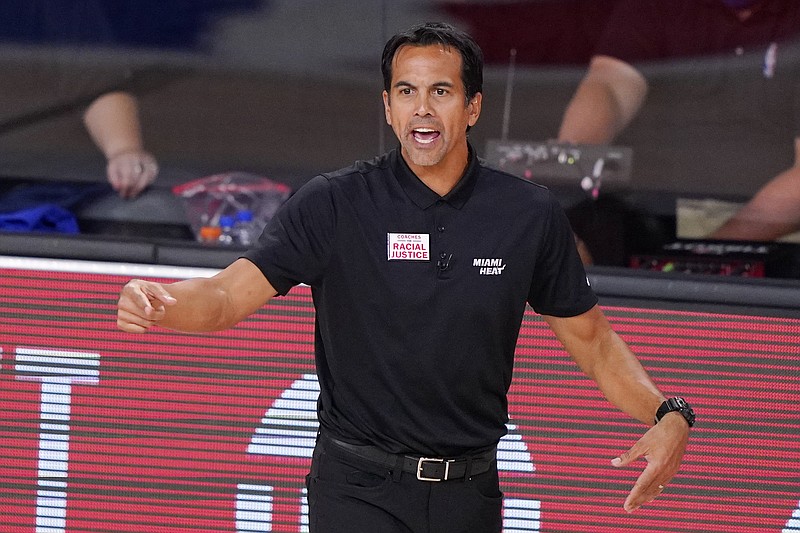 Miami Heat head coach Erik Spoelstra watches the action during the first half of an NBA conference final playoff basketball game between the Heat and the Boston Celtics Friday, Sept. 25, 2020, in Lake Buena Vista, Fla. (AP Photo/Mark J. Terrill)