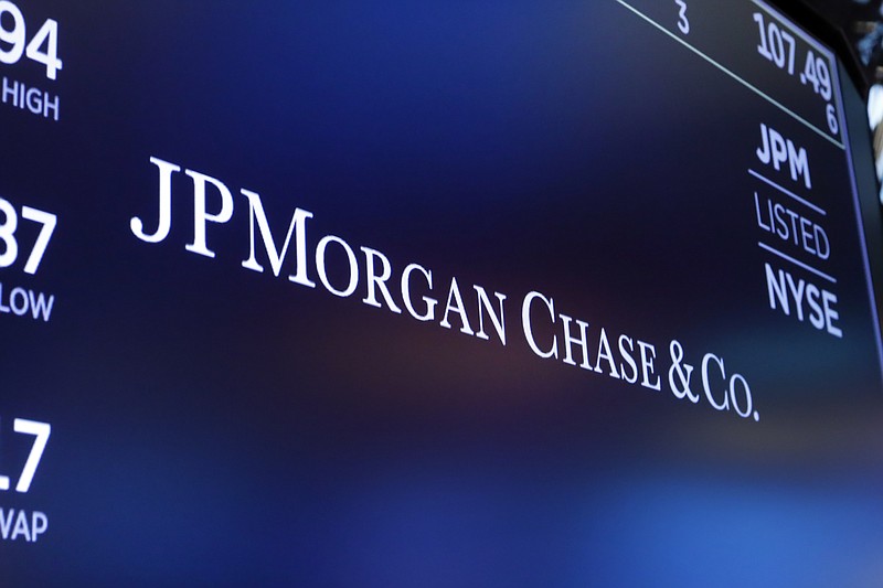 FILE - In this Aug. 16, 2019, file photo, the logo for JPMorgan Chase & Co. appears above a trading post on the floor of the New York Stock Exchange in New York. JPMorgan Chase admitted Tuesday, Sept. 29, 2020 to manipulating the markets for precious metals and U.S. Treasuries, agreeing to pay $920 million in fines and penalties for the illegal behavior. (AP Photo/Richard Drew, File)