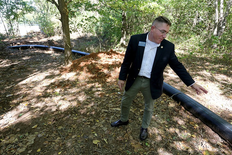 Heath Ward, executive director of Springdale Water Utilities, describes Tuesday, September 29, 2020, the operation of an eight inch continual polyethylene pipe from the former failing Bethel Heights water treatment plant to a connection  with a Springdale sewer line. Check out nwaonline.com/200930Daily/ and nwadg.com/photos for a photo gallery.(NWA Democrat-Gazette/David Gottschalk)