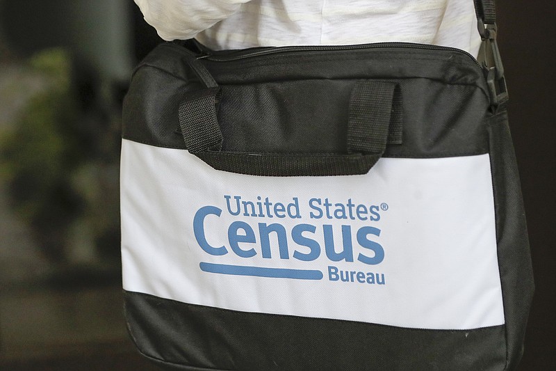 A briefcase of a census taker is seen as she knocks on the door of a residence Tuesday, Aug. 11, 2020, in Winter Park, Fla. A half-million census takers head out en mass this week to knock on the doors of households that haven't yet responded to the 2020 census. (AP Photo/John Raoux)