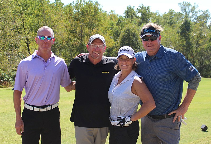 Doon Muehlbach (from left), Chad Warford, Erica and Nels Madsen play in the benefit golf tournament to benefit Havenwood on Oct. 1 at Dogwood Hills Golf Course in Bella Vista. 
(NWA Democrat-Gazette/Carin Schoppmeyer)