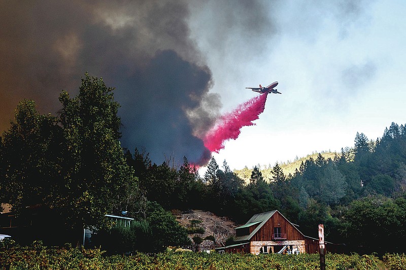 An air tanker drops retardant while battling the Glass Fire in St. Helena, Calif., on Sunday, Sept. 27, 2020. (AP Photo/Noah Berger)
