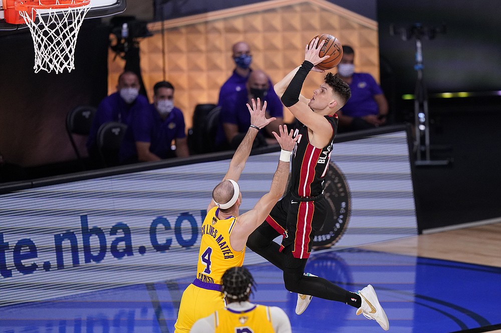 Miami Heat's Tyler Herro, right, drives to the basket against Los Angeles Lakers' Alex Caruso (4) during the second half of Game 1 of basketball's NBA Finals Wednesday, Sept. 30, 2020, in Lake Buena Vista, Fla. (AP Photo/Mark J. Terrill)