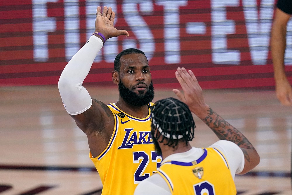 Los Angeles Lakers' LeBron James (23) high-fives Anthony Davis during the second half of Game 1 of basketball's NBA Finals Wednesday, Sept. 30, 2020, in Lake Buena Vista, Fla. (AP Photo/Mark J. Terrill)