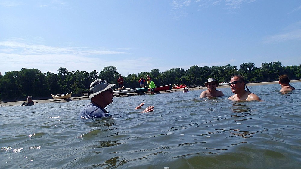 Trip leader Mark Vehlewald of St. Charles, Ill., enjoys a Missouri River swim Aug. 30 with fellow paddlers.
(NWA Democrat-Gazette/Flip Putthoff)
