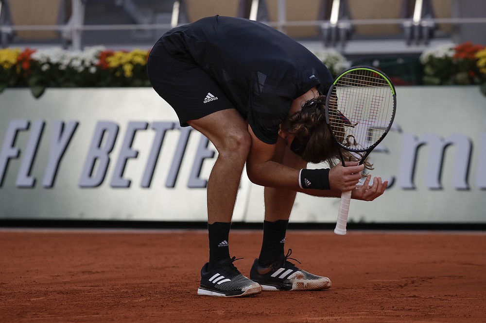 Greece's Stefanos Tsitsipas reacts after missing a shot against Uruguay's Pablo Cuevas in the second round match of the French Open tennis tournament at the Roland Garros stadium in Paris, France, Thursday, Oct. 1, 2020. (AP Photo/Alessandra Tarantino)