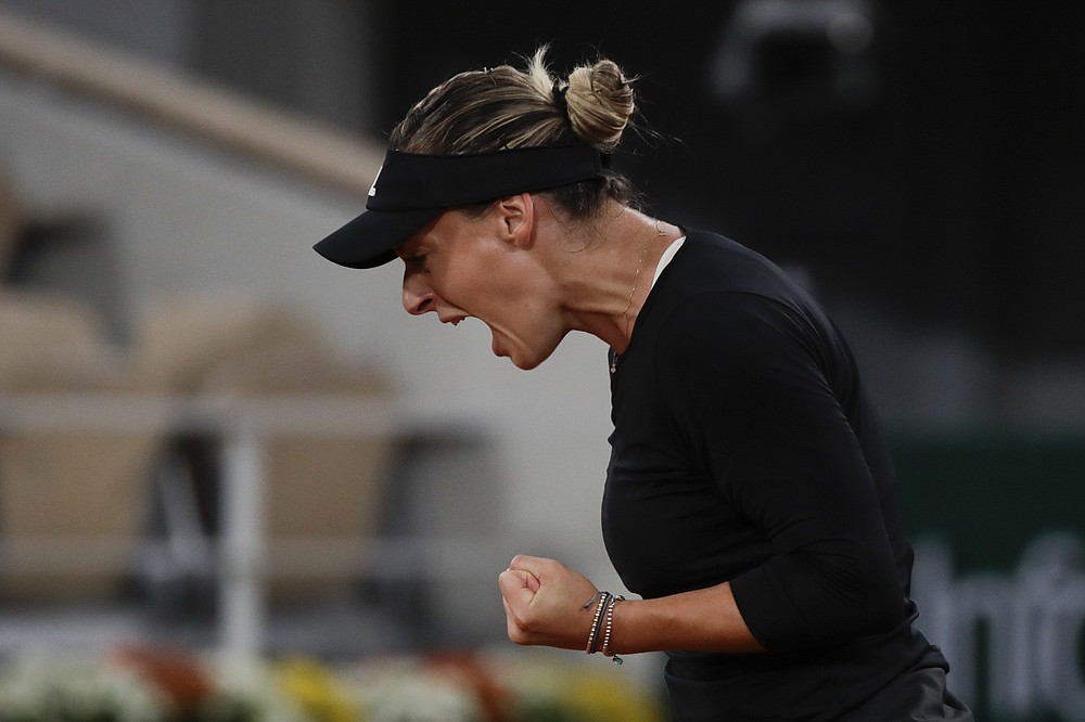 Romania's Ana Bogdan clenches her fist after scoring a point against Sofia Kenin of the U.S. in the second round match of the French Open tennis tournament at the Roland Garros stadium in Paris, France, Thursday, Oct. 1, 2020. (AP Photo/Alessandra Tarantino)