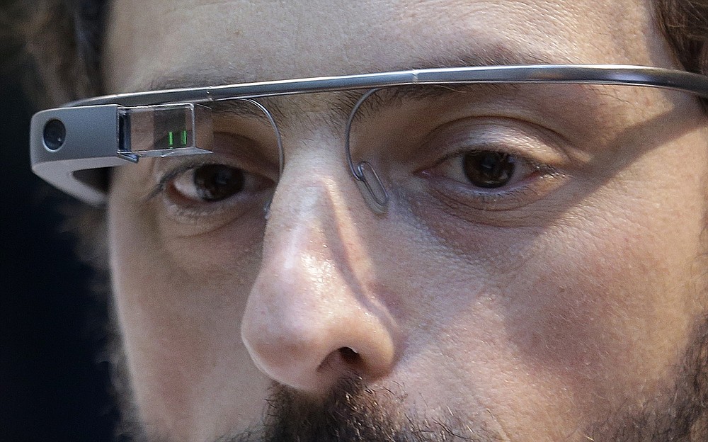 FILE - In this Feb. 20 2013 file photo, Google co-founder Sergey Brin wears a Google Glass device in San Francisco. Brin immigrated to the United States with his family from the Soviet Union at the age of six. From AT&T's Alexander Graham Bell to Brin, immigrants have long been more likely than native-born Americans to realize the dream of owning their own company. A federal judge on Thursday, Oct. 1, 2020, temporarily lifted a visa ban on a large number of work permits, undercutting a measure that the Trump administration says will protect American jobs in a pandemic-wracked economy. (AP Photo/Jeff Chiu, File)