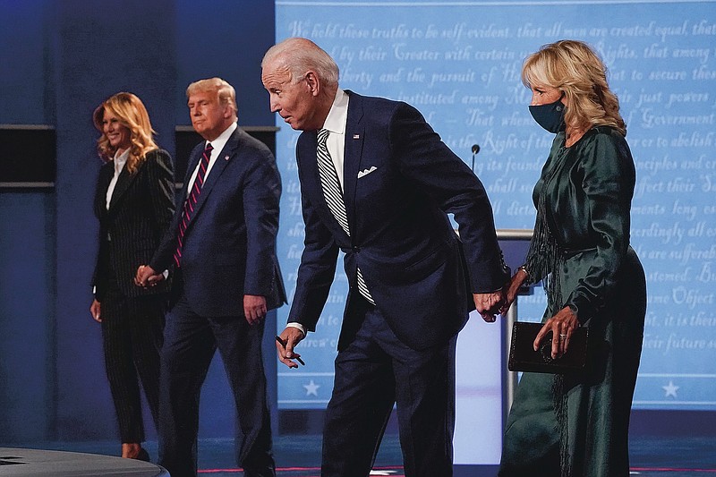 First lady Melania Trump, from left, President Donald Trump, Democratic presidential candidate former Vice President Joe Biden and Jill Biden stand on stage after the first presidential debate at Case Western University and Cleveland Clinic, in Cleveland, Ohio, Sept. 29, 2020. (AP Photo/Julio Cortez)