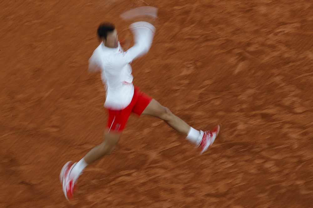 Serbia's Novak Djokovic plays a shot against Colombia's Daniel Elahi Galan in the third round match of the French Open tennis tournament at the Roland Garros stadium in Paris, France, Saturday, Oct. 3, 2020. (AP Photo/Christophe Ena)