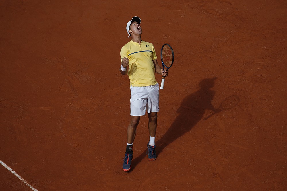 Germany's Daniel Altmaier screams after scoring a point against Italy's Matteo Berrettini in the third round match of the French Open tennis tournament at the Roland Garros stadium in Paris, France, Saturday, Oct. 3, 2020. (AP Photo/Christophe Ena)