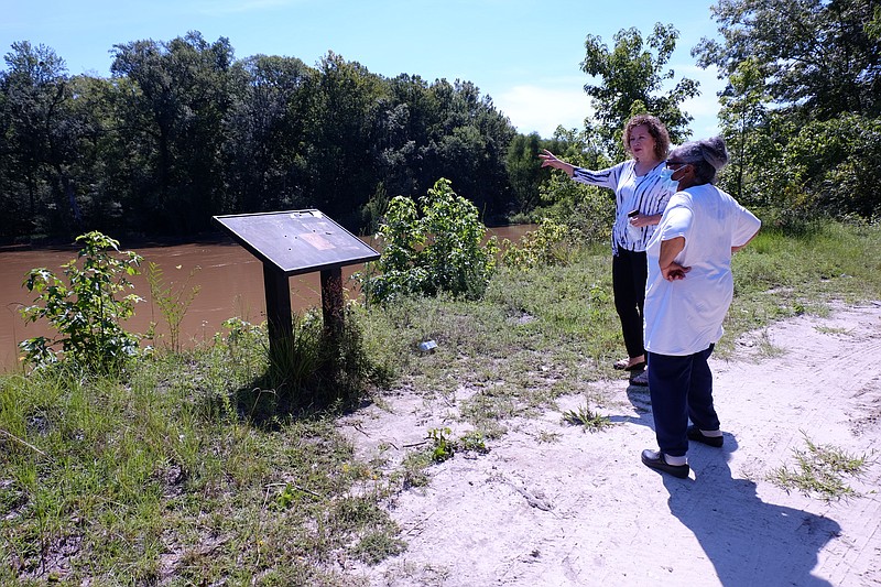 Kathy Andrews, left, speaks with Reatha Jefferson by the Great Pee Dee River Monday, Aug. 17, 2020 in Pamplico, S.C.. Andrews and Jefferson have rallied other town residents to oppose a 14.5-mile-long gas line proposal by Dominion Energy. (AP Photo/Michelle Liu)