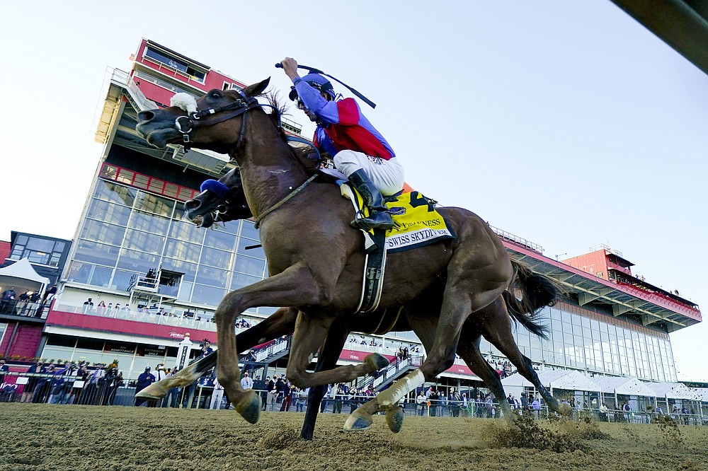 FILE - In this Oct. 3, 2020, file photo, Swiss Skydiver (4), with Robby Albarado aboard, wins the 145th Preakness Stakes horse race at Pimlico Race Course in Baltimore. Obscured behind Swiss Skydiver is Authentic, ridden by John Velazquez. After an out-of-order Triple Crown with a different horse winning the Belmont, Kentucky Derby and Preakness, it might be a long time until Tiz the Law, Authentic and Swiss Skydiver all race against one another. That is, unless Swiss Skydiver challenges them and older males in the Breeders’ Cup Classic on Nov. 7, which is expected to be a Tiz the Law/Authentic rematch. (AP Photo/Steve Helber, File)